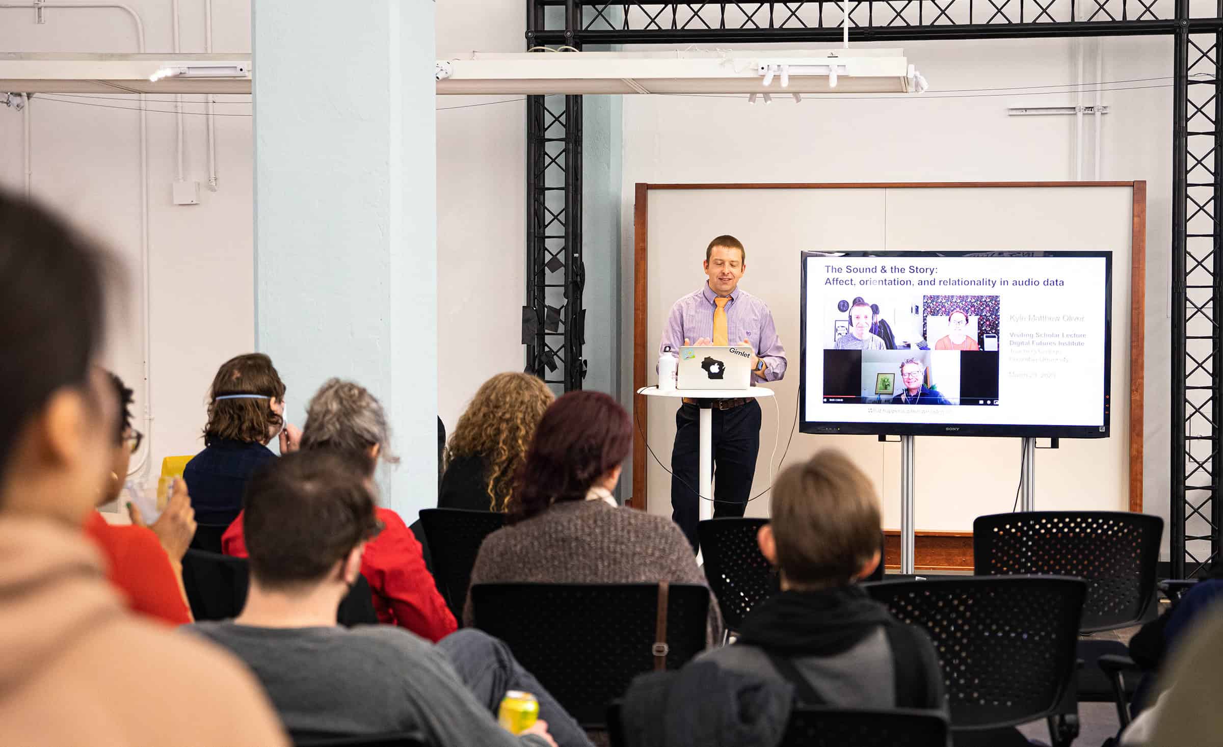 Kyle speaks during presentation in gallery space